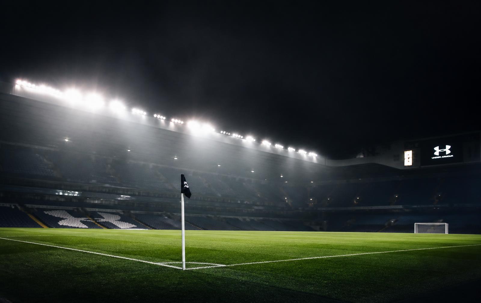 Floodlit football stadium at night